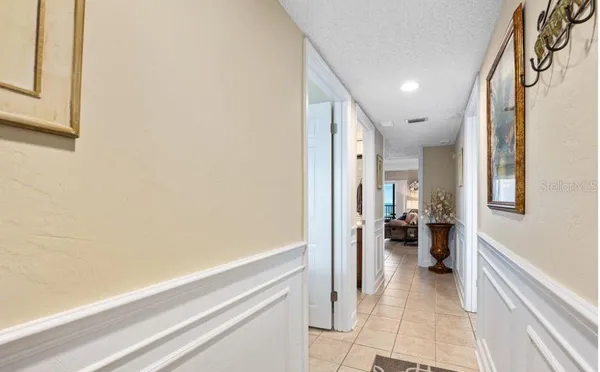 a view of a hallway and a livingroom with furniture