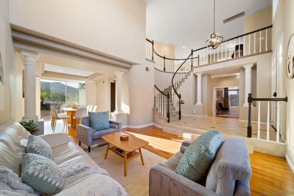 a living room with furniture and a chandelier