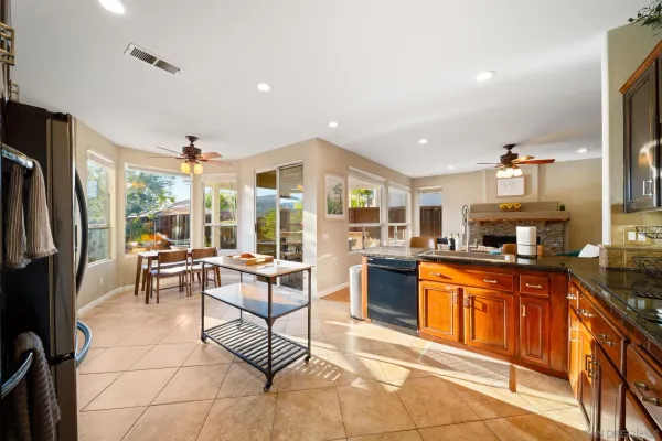 a kitchen with granite countertop a sink stove and cabinets