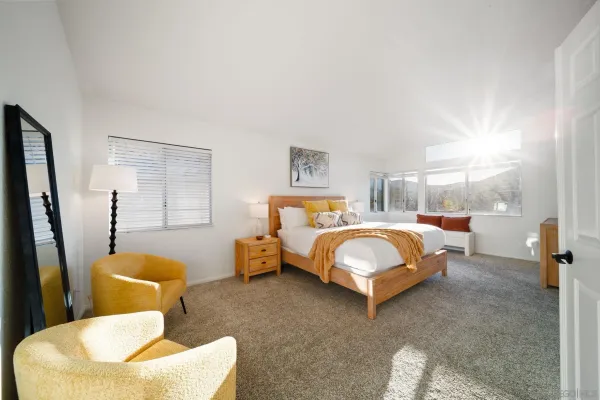 a bedroom with bed and glass door