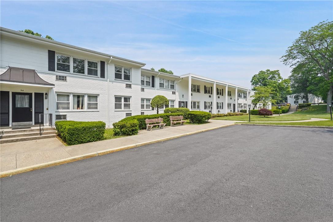 28 North Ridge Street, Unit D Rye Brook, NY 10573 - Photo 1 of 1 a front view of residential houses with yard and green space