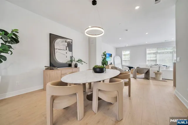 a kitchen with a refrigerator and white cabinets
