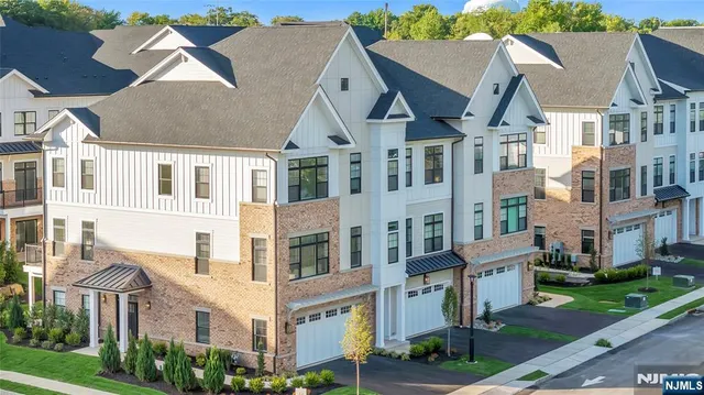 a view of multiple houses with a big yard
