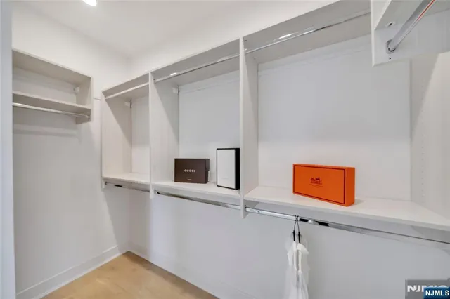 a large bed sitting in a bedroom next to a window