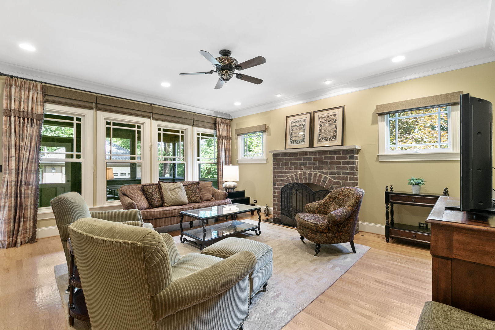 362 Downing Road Riverside, IL 60546 - Photo 11 of 40 a living room with furniture a fireplace and a flat screen tv