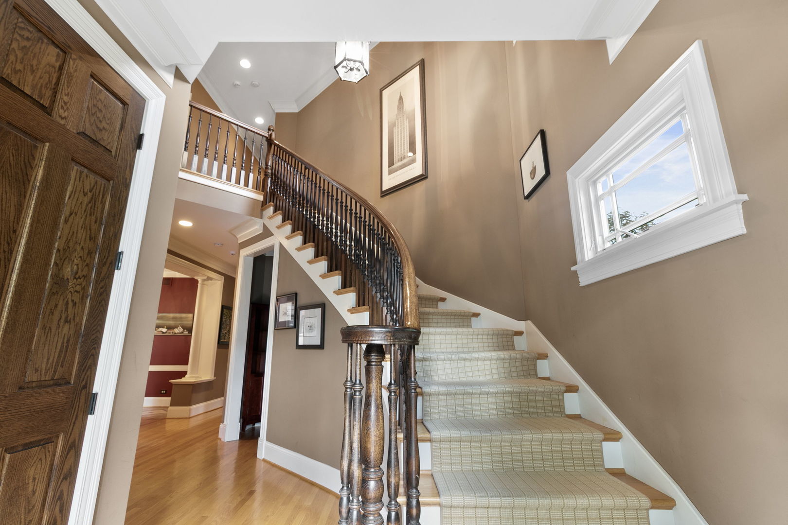 362 Downing Road Riverside, IL 60546 - Photo 2 of 40 a view of staircase with lots of frames on wall and wooden floor