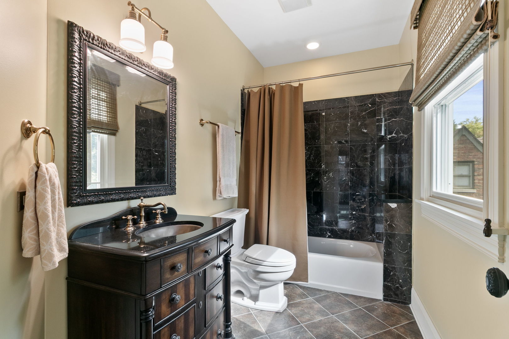 362 Downing Road Riverside, IL 60546 - Photo 25 of 40 a bathroom with a granite countertop sink toilet a mirror a bathtub and shower