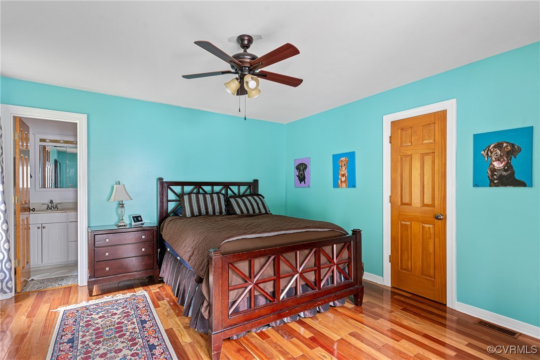 4405 Rabbit Foot Place Chesterfield, VA 23236 - Photo 31 of 38 a bedroom with a bed a dresser and potted plant