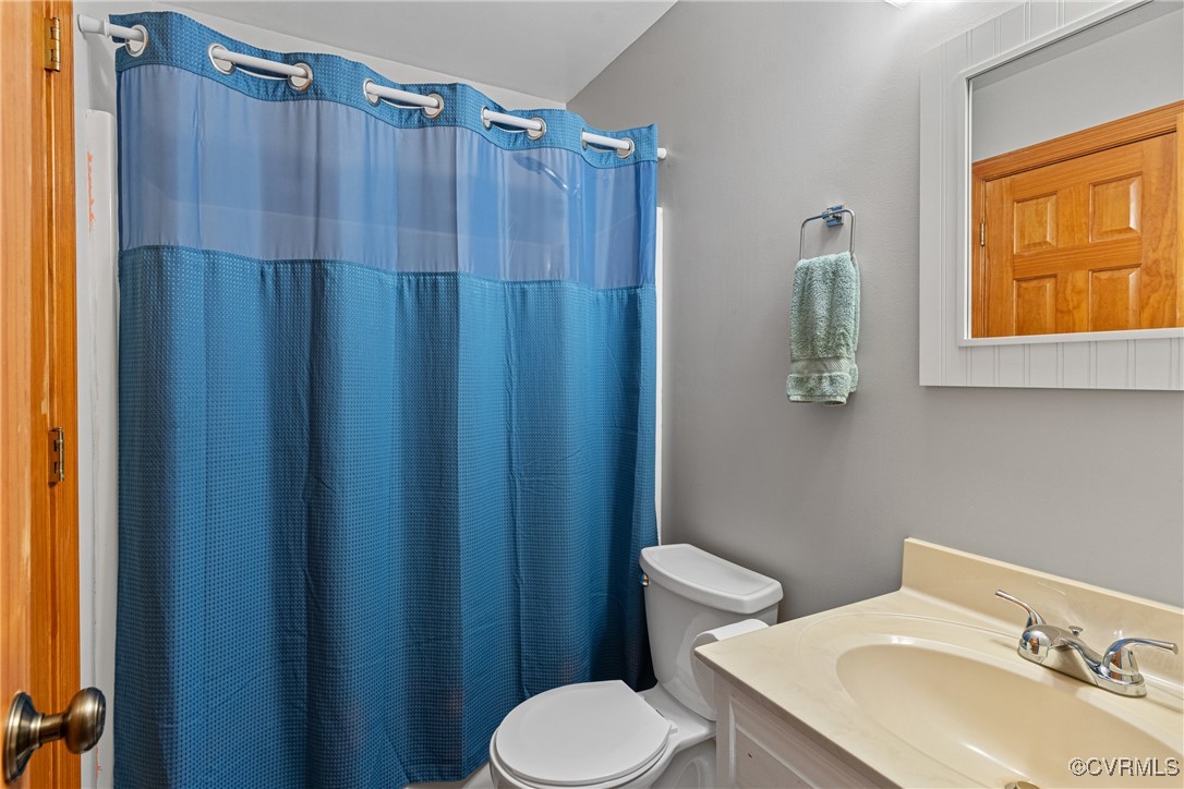 4405 Rabbit Foot Place Chesterfield, VA 23236 - Photo 36 of 38 a bathroom with a sink a toilet and shower curtain