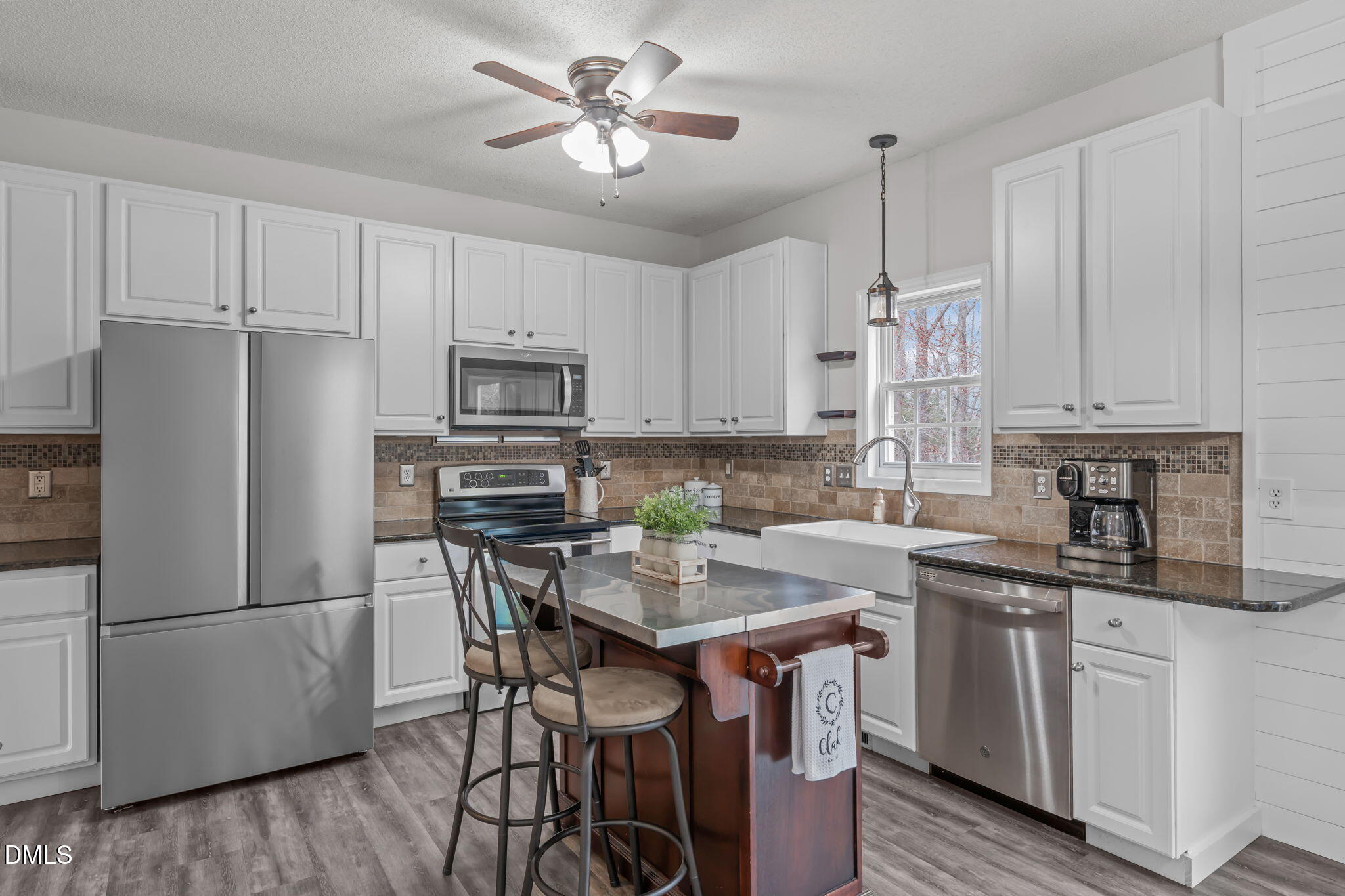 2501 Springfield Park Drive Raleigh, NC 27614 - Photo 12 of 44 a kitchen with stainless steel appliances a white refrigerator a sink a stove a dining table and chairs