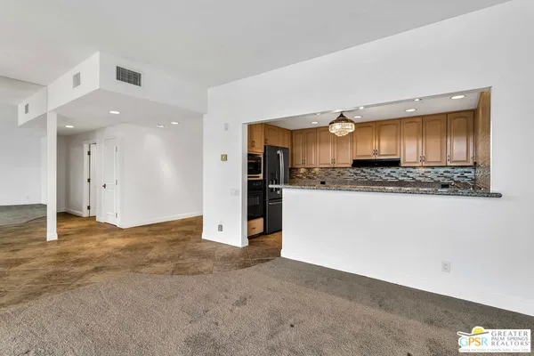 a view of kitchen and refrigerator