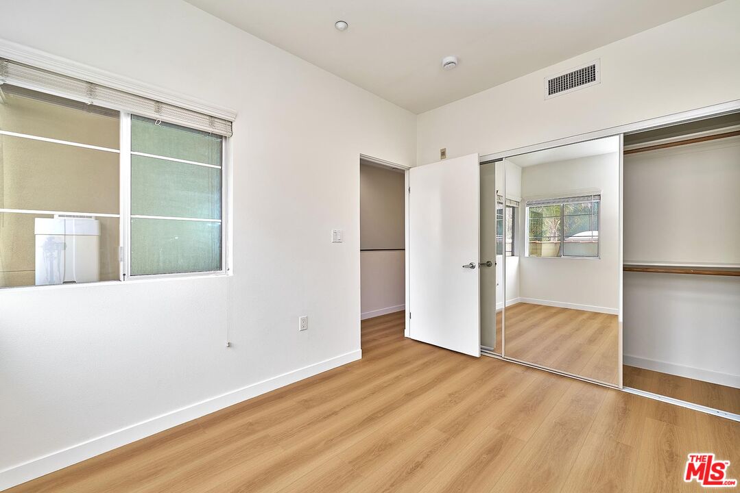 2864 Sunset Place, Unit 203 Los Angeles, CA 90005 - Photo 11 of 21 a view of hallway with wooden floor and cabinet