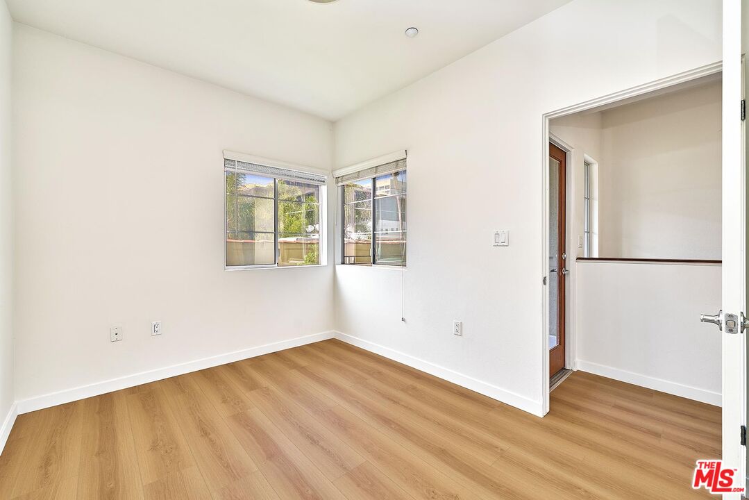 2864 Sunset Place, Unit 203 Los Angeles, CA 90005 - Photo 14 of 21 an empty room with wooden floor and a window