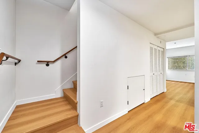 a view of a room with wooden floor and staircase
