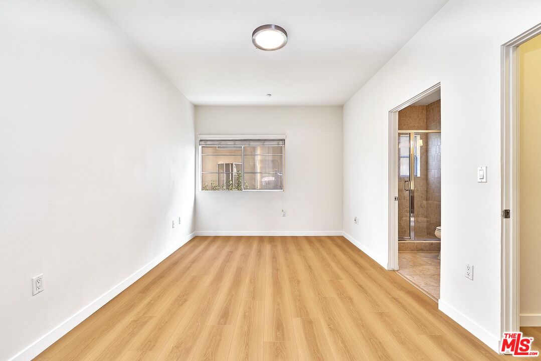 2864 Sunset Place, Unit 203 Los Angeles, CA 90005 - Photo 9 of 21 a view of a room with wooden floor and windows