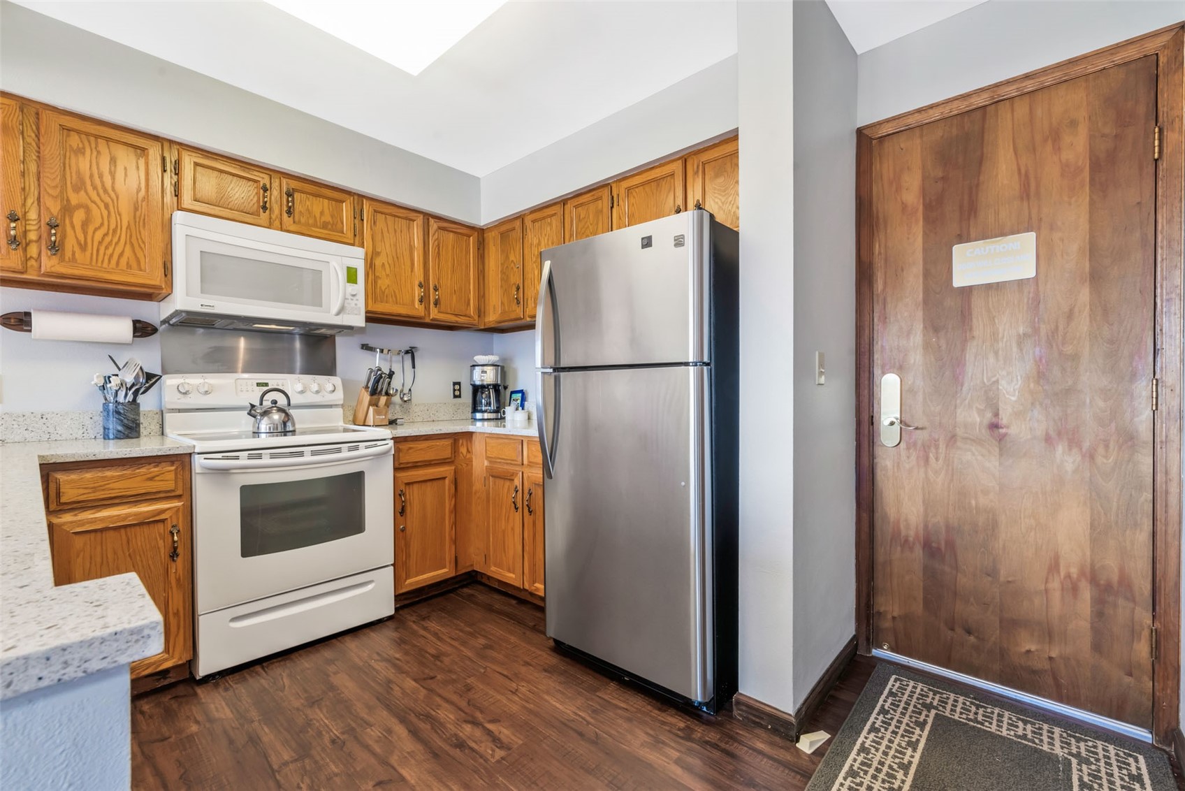 1720 Ranch Road, Unit 309 Steamboat Springs, CO 80487 - Photo 17 of 43 a kitchen with a refrigerator sink and cabinets