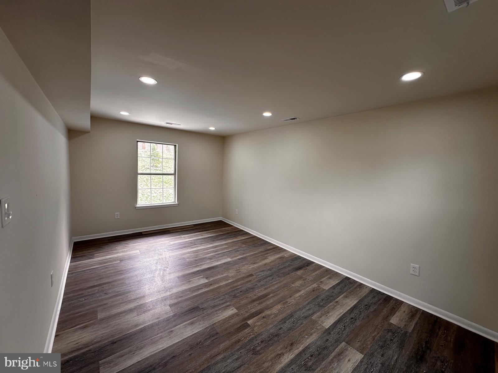 12800 Asbury Drive Fort Washington, MD 20744 - Photo 19 of 53 a view of an empty room with wooden floor and a window