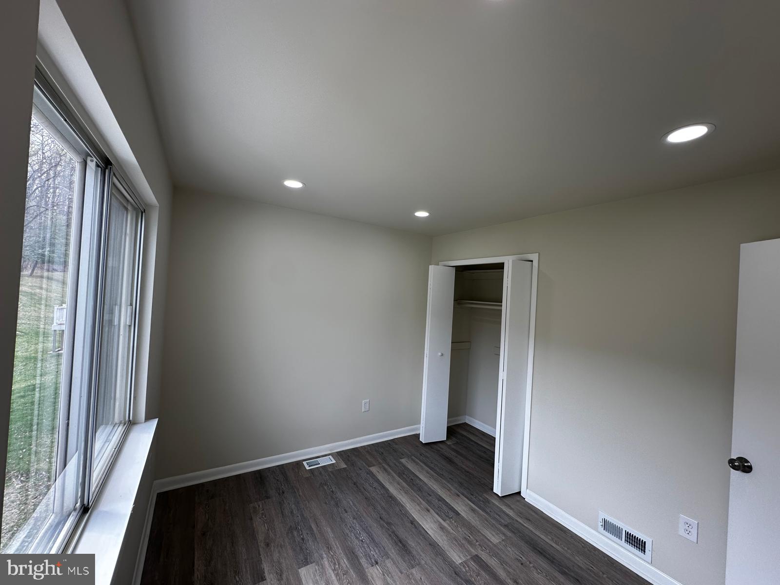 12800 Asbury Drive Fort Washington, MD 20744 - Photo 32 of 53 an empty room with wooden floor and a window