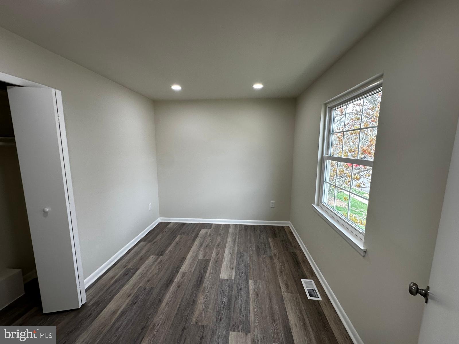 12800 Asbury Drive Fort Washington, MD 20744 - Photo 35 of 53 an empty room with wooden floor and windows