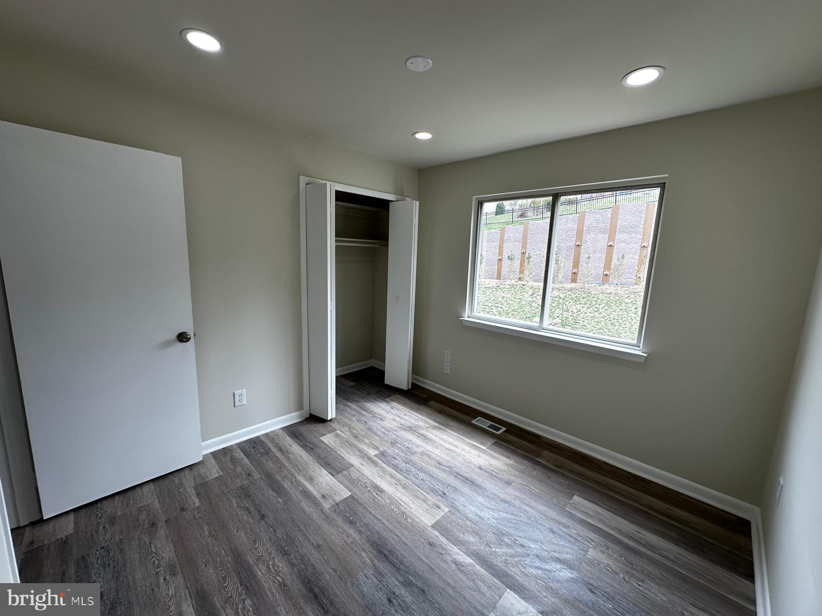 12800 Asbury Drive Fort Washington, MD 20744 - Photo 38 of 53 an empty room with wooden floor and windows