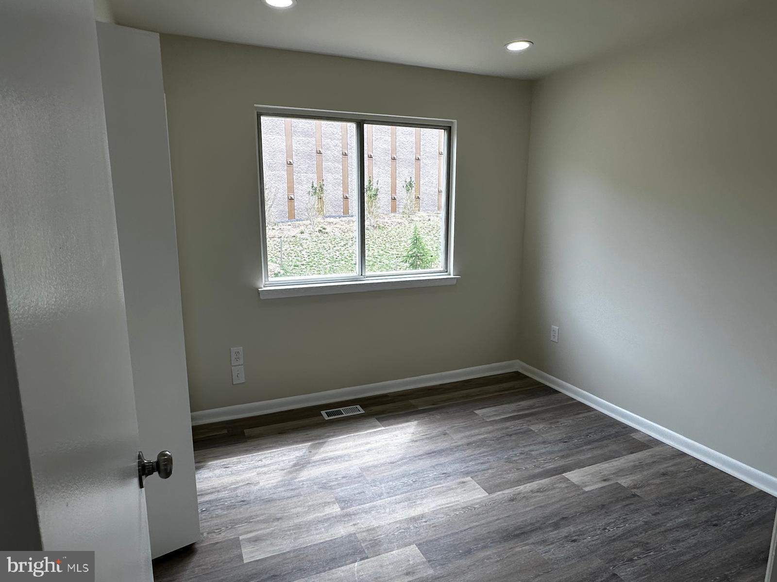 12800 Asbury Drive Fort Washington, MD 20744 - Photo 39 of 53 an empty room with wooden floor and windows
