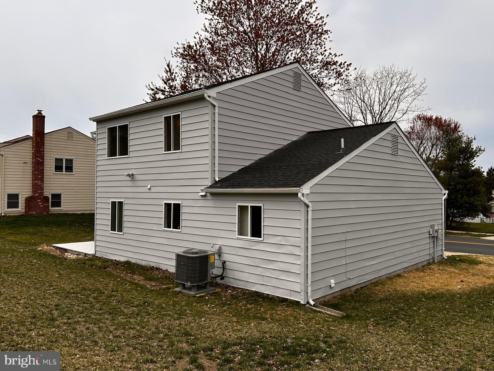 12800 Asbury Drive Fort Washington, MD 20744 - Photo 6 of 53 a view of a white house with a yard and lawn chairs under an umbrella