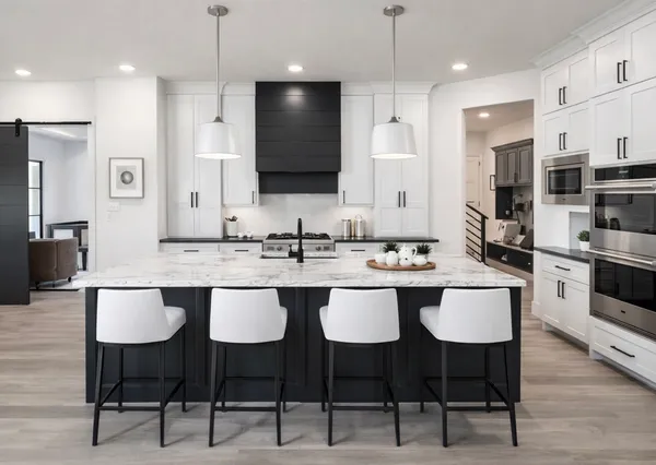 a kitchen with granite countertop a sink and chairs