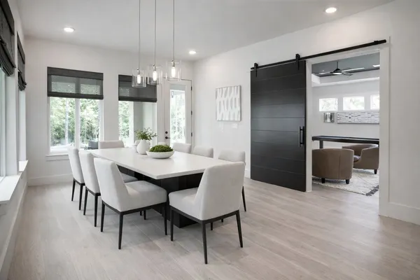 a dining room with furniture a chandelier and wooden floor