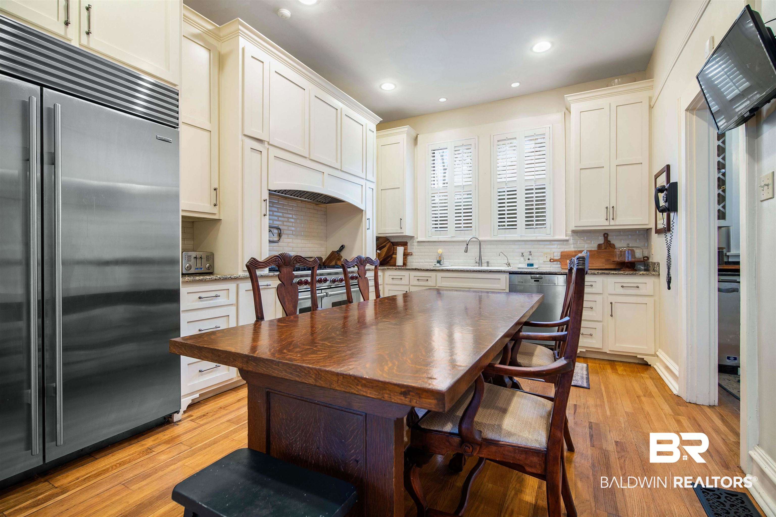 1314 Dauphin Street Mobile, AL 36604 - Photo 27 of 61 Kitchen with light hardwood floors, sink, appliances with stainless steel finishes, and tasteful backsplash