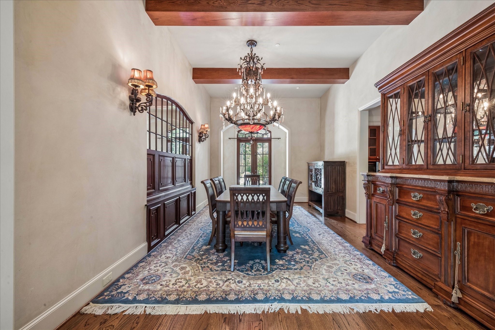 802 Country Lane Houston, TX 77024 - Photo 14 of 34 a dining room with wooden floor a chandelier a wooden table and chairs