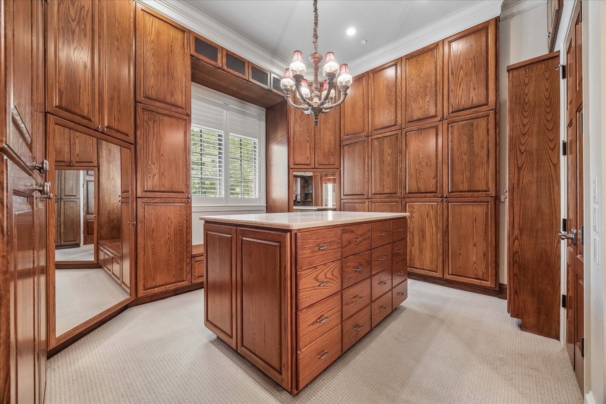 802 Country Lane Houston, TX 77024 - Photo 20 of 34 a room with kitchen island cabinets and chandelier