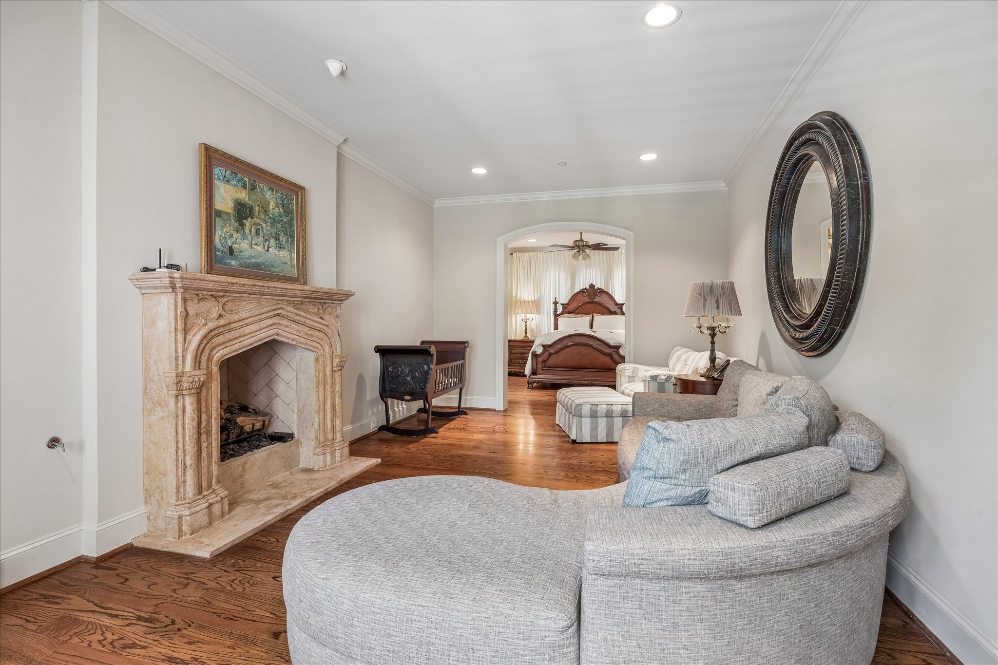802 Country Lane Houston, TX 77024 - Photo 21 of 34 a living room with furniture a mirror and a fireplace
