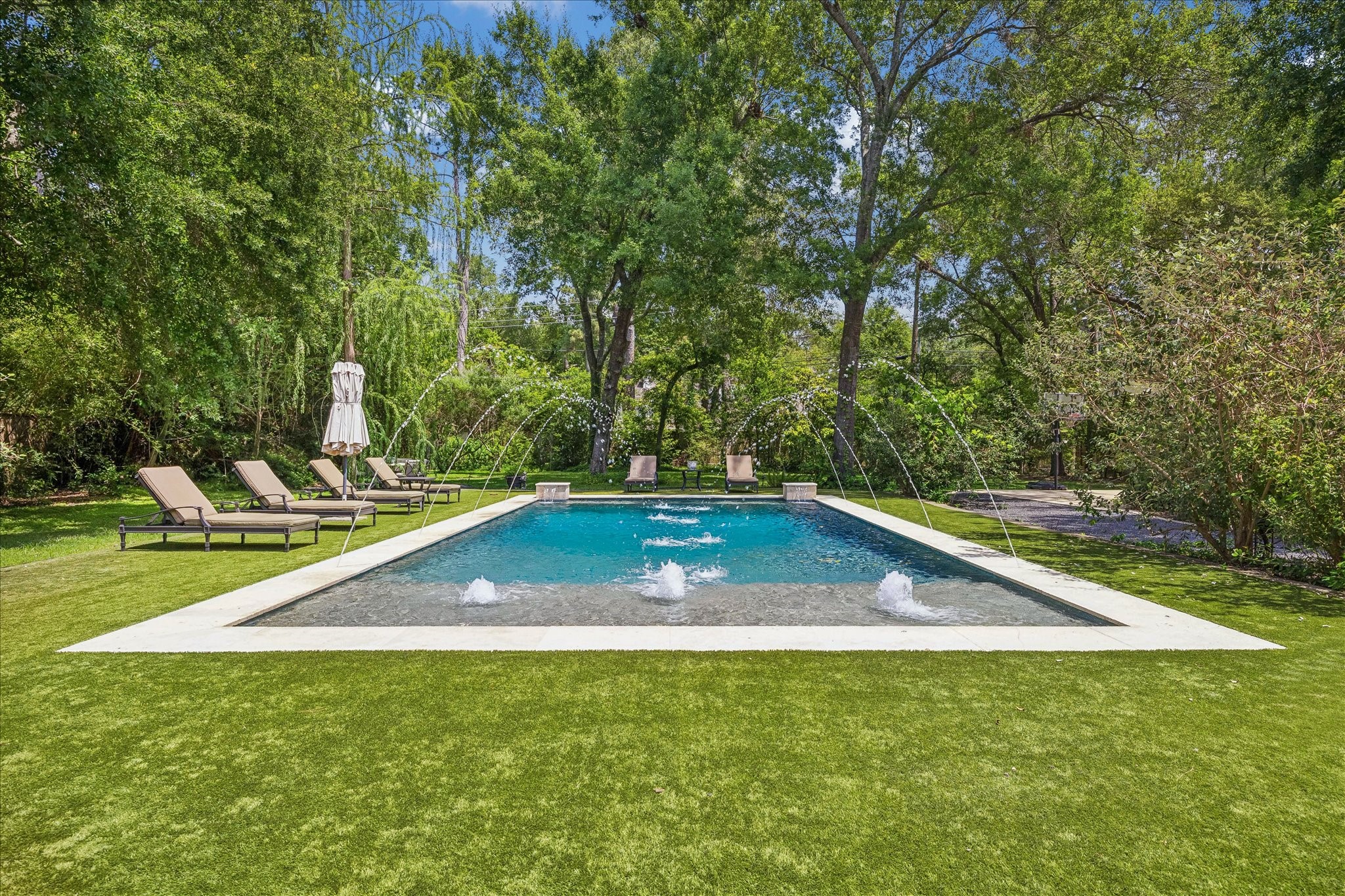802 Country Lane Houston, TX 77024 - Photo 32 of 34 a view of a swimming pool with a yard