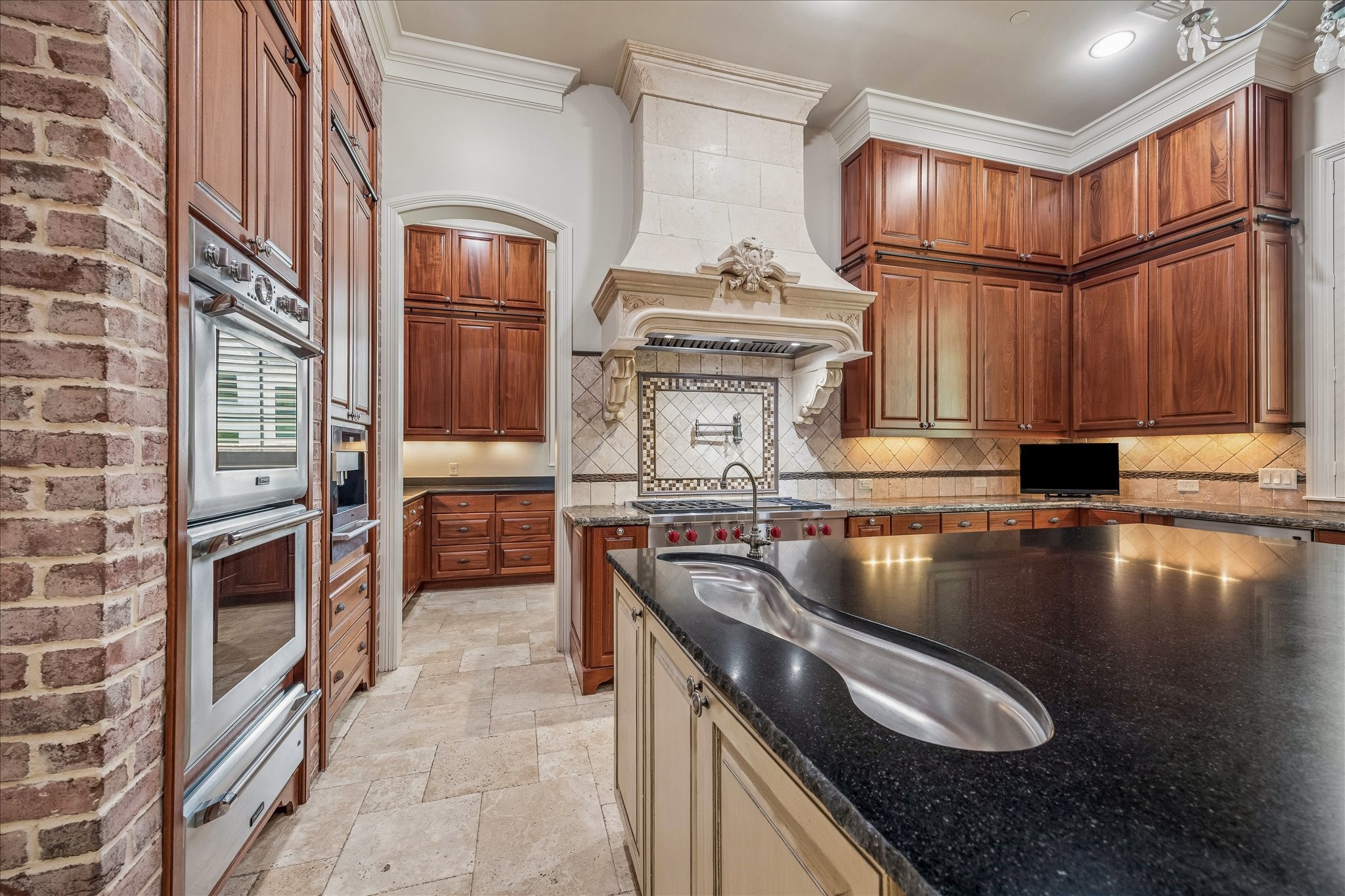 802 Country Lane Houston, TX 77024 - Photo 7 of 34 a kitchen with granite countertop a stove and a sink