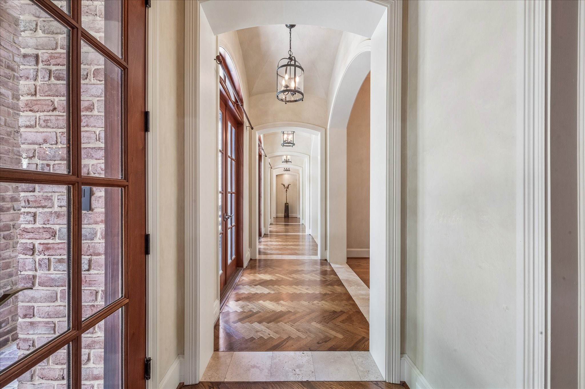 802 Country Lane Houston, TX 77024 - Photo 10 of 34 a view of a hallway with a door and windows