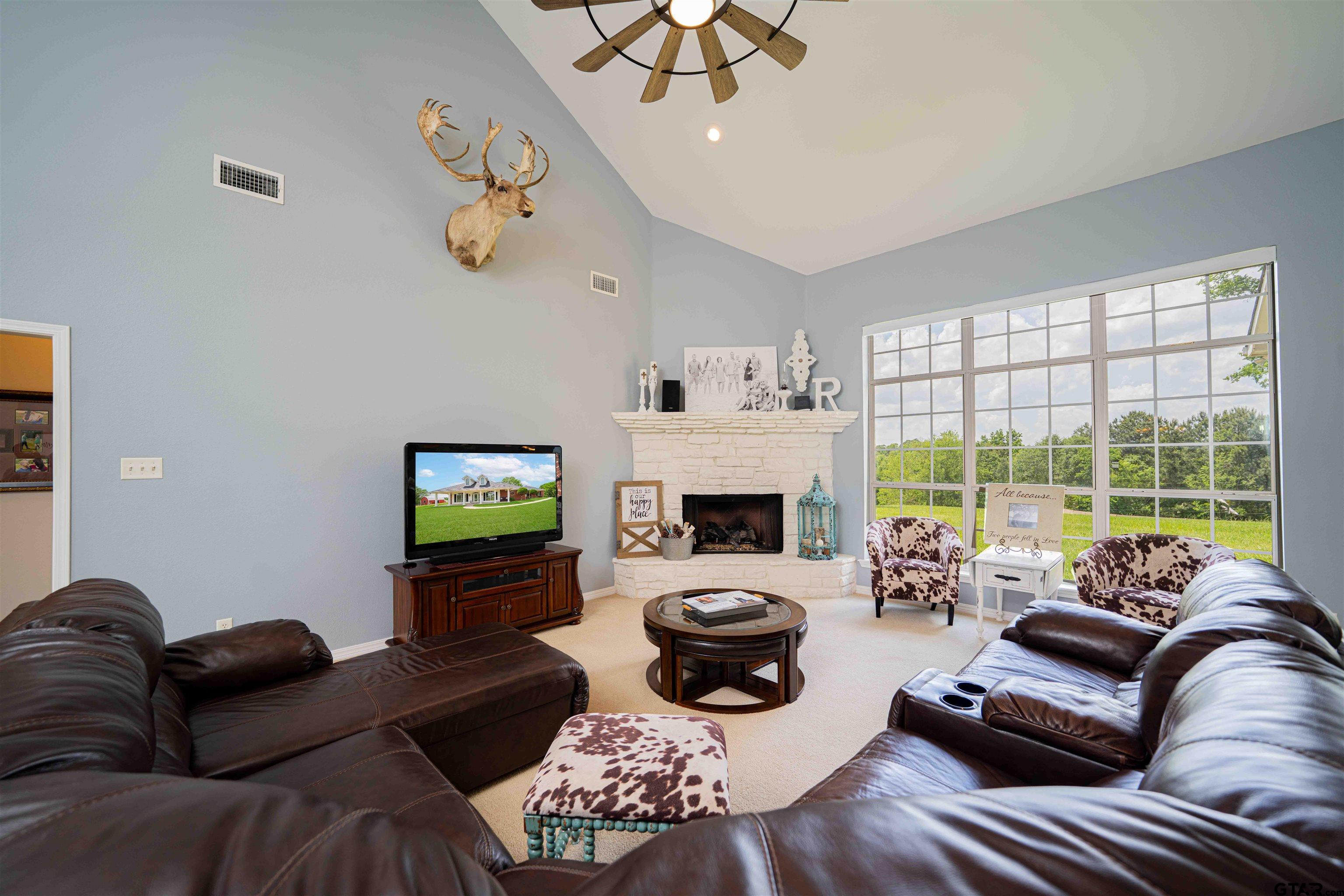 1855 Phillips Springs Road Gladewater, TX 75647 - Photo 4 of 36 a living room with furniture fireplace and a large window