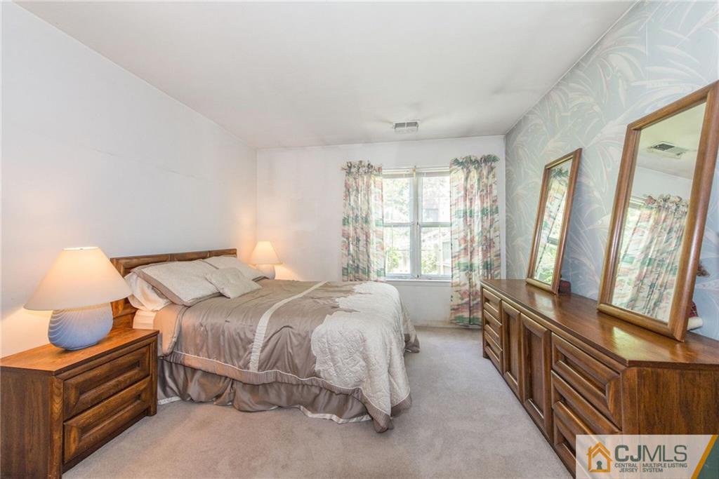 8 Woodbury Road Edison, NJ 08820 - Photo 11 of 18 a bed room with a bed and a window
