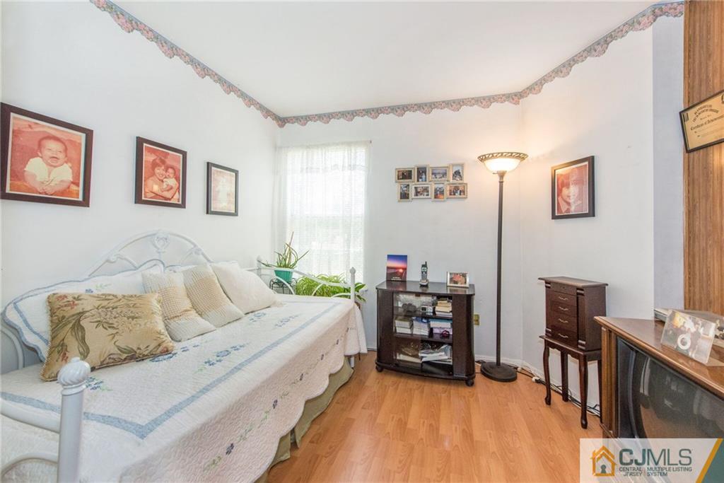 8 Woodbury Road Edison, NJ 08820 - Photo 14 of 18 a living room with furniture and a wooden floor