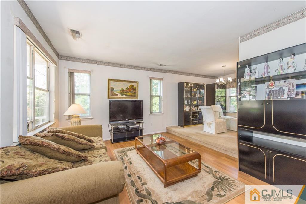 8 Woodbury Road Edison, NJ 08820 - Photo 3 of 18 a living room with furniture and a flat screen tv