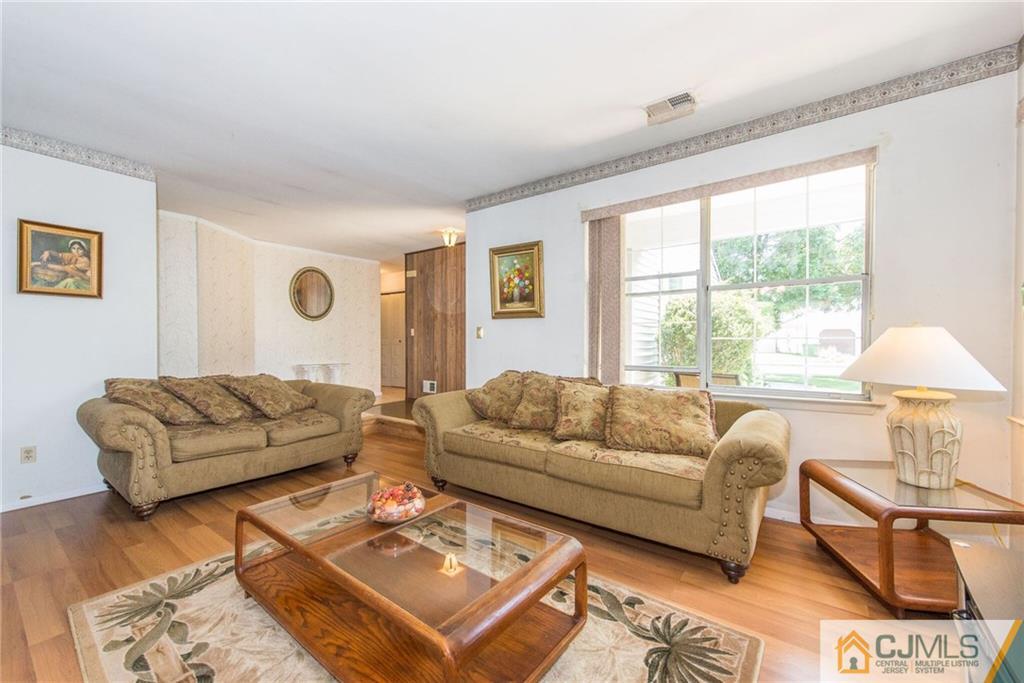 8 Woodbury Road Edison, NJ 08820 - Photo 5 of 18 a living room with furniture and a large window