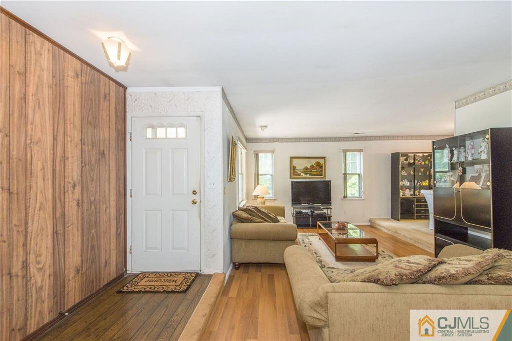 8 Woodbury Road Edison, NJ 08820 - Photo 6 of 18 a living room with furniture and a flat screen tv