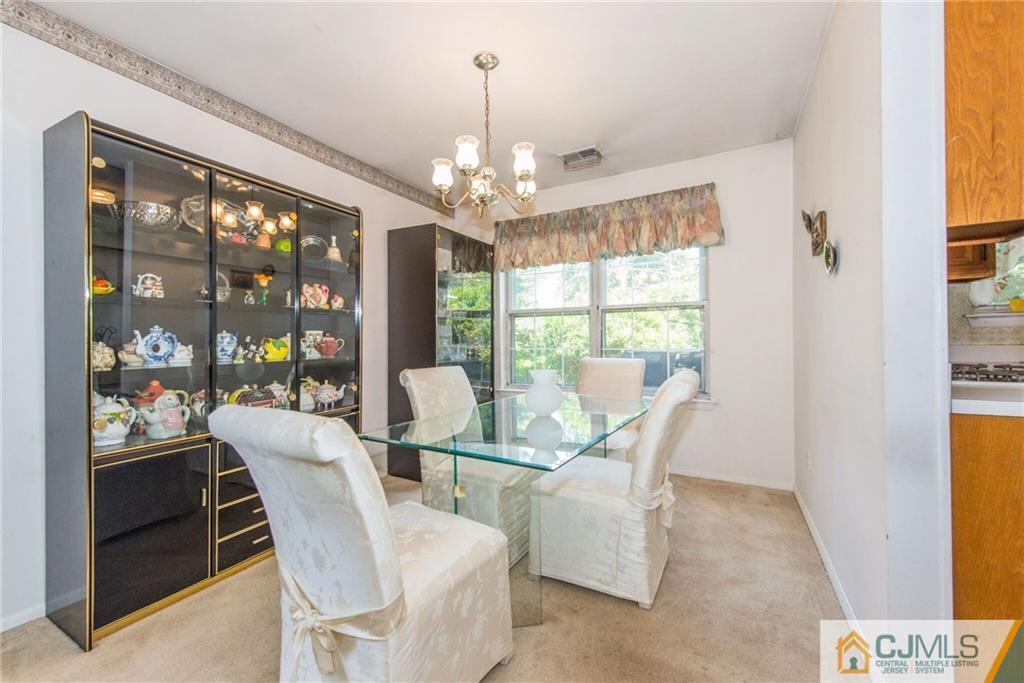 8 Woodbury Road Edison, NJ 08820 - Photo 7 of 18 a view of a dining room with furniture large windows and wooden floor