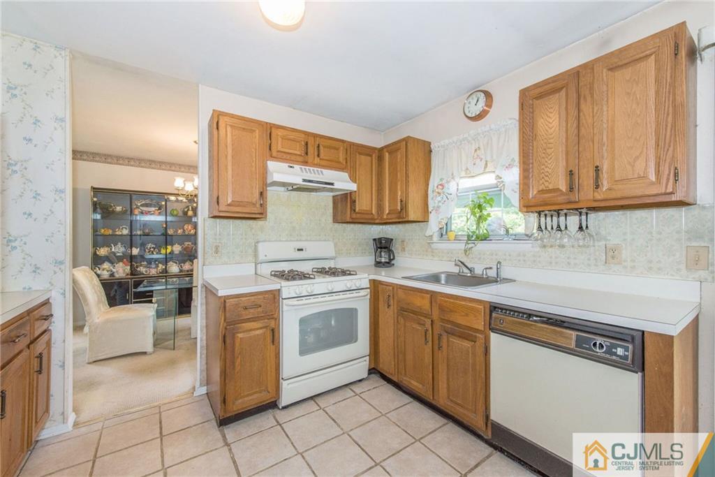 8 Woodbury Road Edison, NJ 08820 - Photo 10 of 18 a kitchen with stainless steel appliances granite countertop a stove a sink and a refrigerator