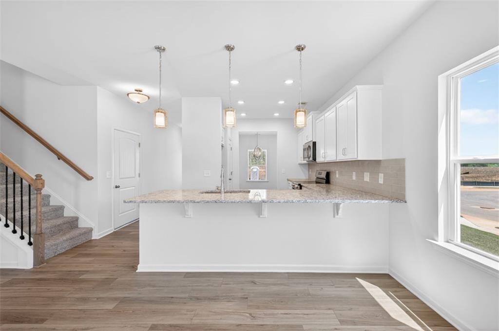 723 Sinclair Lane Temple, GA 30179 - Photo 11 of 40 a large kitchen with lots of counter space wooden floor and appliances