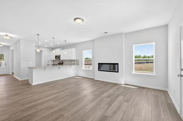 a view of empty room with wooden floor