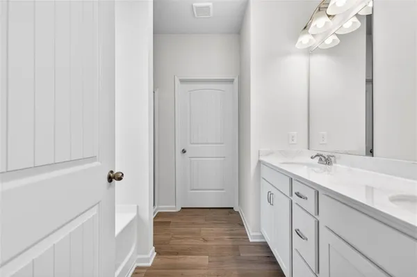 a bathroom with double vanity sinks and a mirror