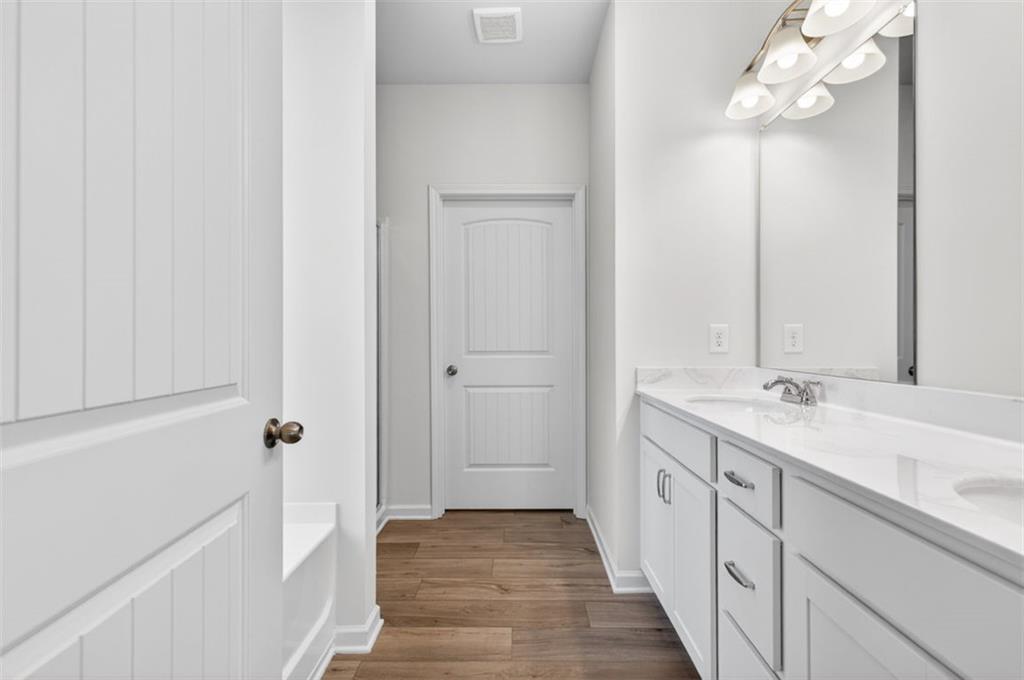 723 Sinclair Lane Temple, GA 30179 - Photo 21 of 40 a bathroom with a double vanity sink and mirror with shower