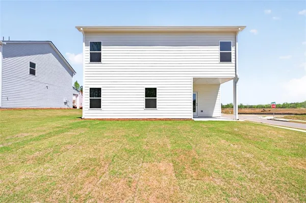 a view of a patio with a table and chairs under an umbrella