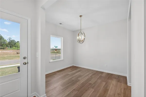 a view of a room with wooden floor and window