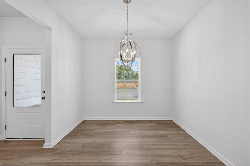 723 Sinclair Lane Temple, GA 30179 - Photo 7 of 40 a view of empty room with wooden floor and fan